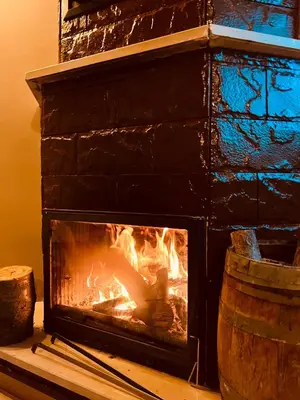 a brick fireplace with a fire in it at Niceland İznik