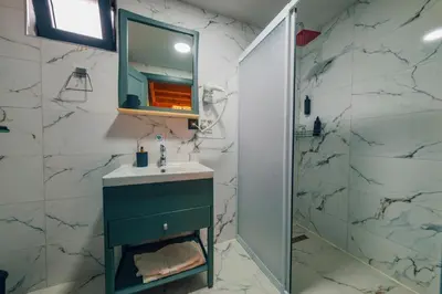 a bathroom with a sink and a mirror at Say Resort Bungalov in Sapanca