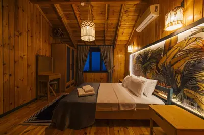 a bedroom with a bed in a room with wooden walls at Say Resort Bungalov in Sapanca