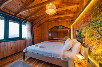 a bedroom with a bed in a wooden cabin at Say Resort Bungalov in Sapanca