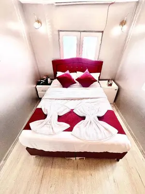 a bedroom with a large bed with a red headboard at Taksim Luxury Capital Hotel in Istanbul