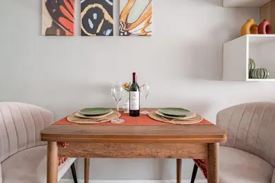 a table with a bottle of wine and glasses on it at Kadıköy ün Kalbinde Tarihi Rahat Sessiz Daire in Istanbul