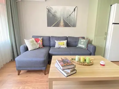 a living room with a blue couch and a coffee table at Kadıköy ün Kalbinde Tarihi Rahat Sessiz Daire in Istanbul