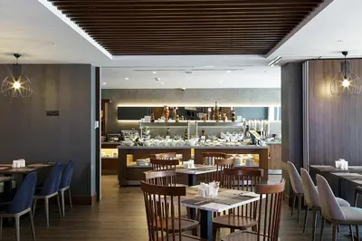 a restaurant with tables and chairs and a kitchen at Bof Hotels Business in Istanbul