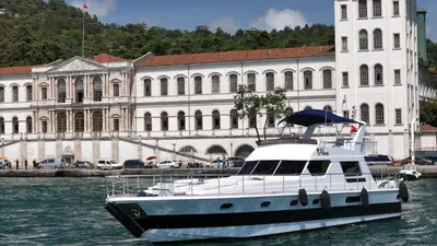 a boat in the water in front of a building at Pruva Yacht in Istanbul