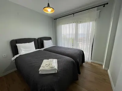 a bedroom with a bed with a pair of shoes on it at Sakarya Sapanca Ünlüce de 5 oda 1 salon Özel Havuzlu Lux 10 kişilik Tatil Villası in Sapanca