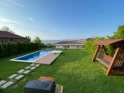 a backyard with a swimming pool with a wooden deck at Sakarya Sapanca Ünlüce de 5 oda 1 salon Özel Havuzlu Lux 10 kişilik Tatil Villası in Sapanca