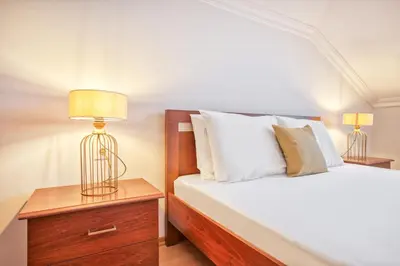 a bedroom with a bed and two lamps on a nightstand at Dublex 3 Bedrooms&2Bathrooms &Terrace in Istanbul