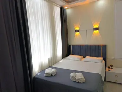 a bedroom with two towels on a bed with a window at King Mas Suit in Istanbul