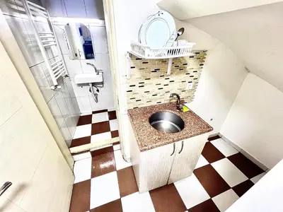 a small bathroom with a sink and a mirror at Taksim White House Hotel in Istanbul