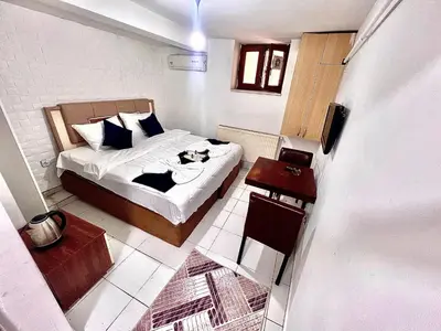 a small bedroom with a bed and a table at Taksim White House Hotel in Istanbul