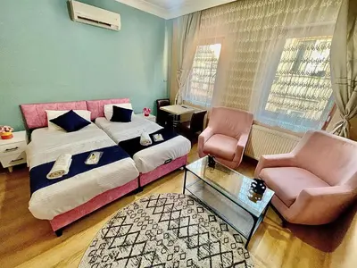 a bedroom with a bed and two chairs and a table at Taksim White House Hotel in Istanbul