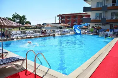 a large swimming pool with a slide in a hotel at Sare Hotel in Erdek