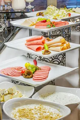 a row of trays filled with different types of food at Arts Hotel Harbiye - Special Class in Istanbul