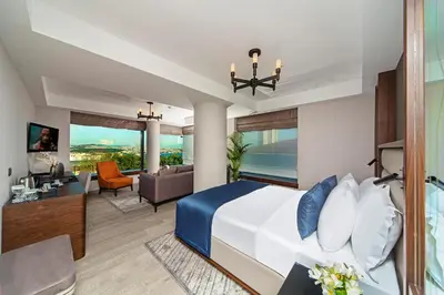 a bedroom with a bed and a living room at Arts Hotel Harbiye - Special Class in Istanbul