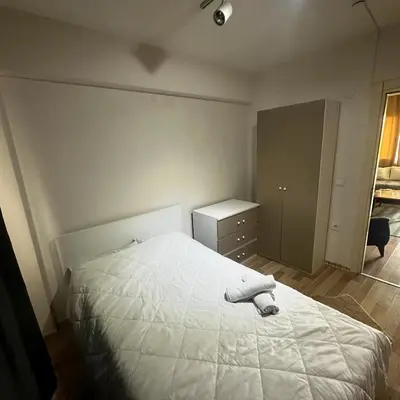 a bedroom with a white bed and a dresser at İstanbulhome in Istanbul