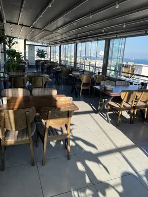 a restaurant with tables and chairs and windows at ORAL hotel in Istanbul