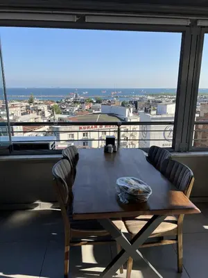 a table and chairs in front of a large window at ORAL hotel in Istanbul