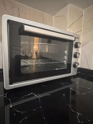 a microwave oven sitting on top of a counter at Taksim Tekir Apartment in Istanbul