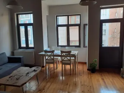 a living room with a table and chairs and a couch at Feridiye 3 Oda 1 salon Daire in Istanbul