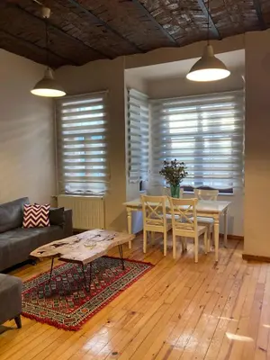 a living room with a table and a couch at Feridiye 3 Oda 1 salon Daire in Istanbul