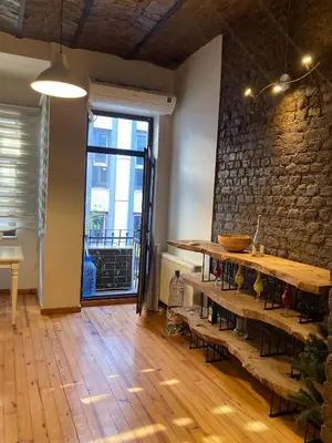 a room with a wooden table and a brick wall at Feridiye 3 Oda 1 salon Daire in Istanbul