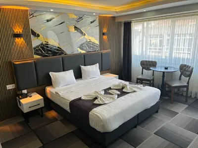 a hotel room with a bed and a painting on the wall at Lizbonia Suit in Istanbul