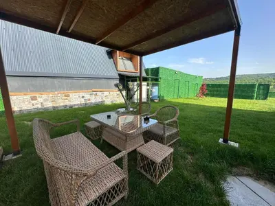 a patio with a table and chairs under a pavilion at Gölköy Bungalov Kandıra in Kandıra