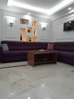 a living room with a purple couch and a coffee table at PERA ARYA Hotel in Istanbul