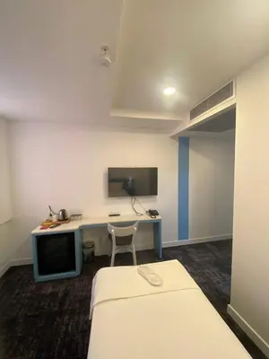 a room with a desk and a bed and a desk with a computer at No25 Hotels in Corlu