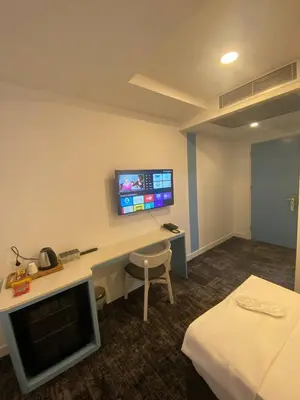 a hotel room with a desk and a tv on the wall at No25 Hotels in Corlu