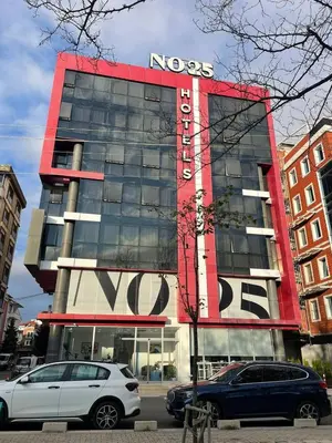 a novas building with cars parked in front of it at No25 Hotels in Corlu