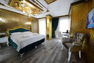 a hotel room with a bed and a chair at Fatih Babel Park Hotel in Istanbul