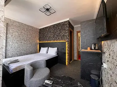 a hotel room with a bed and a chair at MAHAL Otel PENDİK in Istanbul