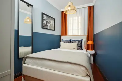 a bedroom with blue walls and a bed with a mirror at Private House near Taksim in Istanbul