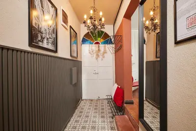 a hallway with a door and a chandelier at Private House near Taksim in Istanbul