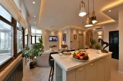 a kitchen and living room with a bowl of fruit on the counter at chic ve modern daire taksim meydani in Istanbul
