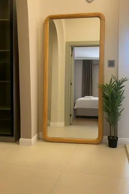 a large wooden mirror in a room with a bedroom at chic ve modern daire taksim meydani in Istanbul