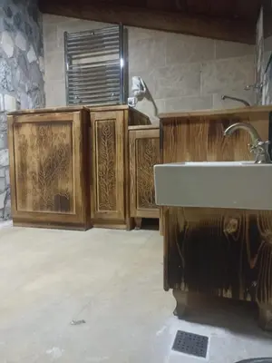 a bathroom with a sink and wooden cabinets at Duru Hanım Konağı in Mudanya