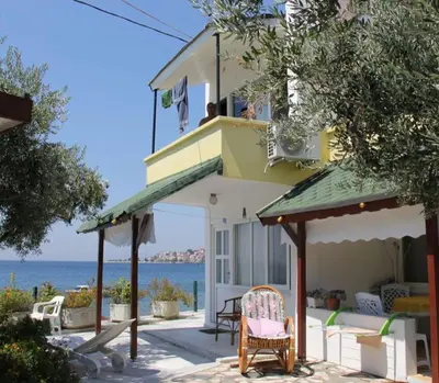 a house with a chair in front of it at boncuk motel in Marmara