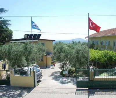 two flags are flying in front of a building at boncuk motel in Marmara