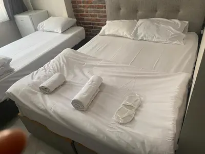 two beds with white sheets and towels on them at lastbest hotel in Istanbul