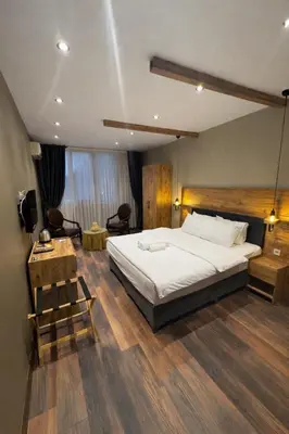 a bedroom with a large white bed in a room at Goga Otel in Sarıyer