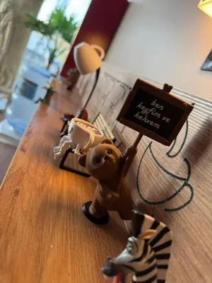 a toy animal holding a sign on a table at Goga Otel in Sarıyer
