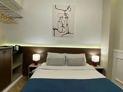 a bedroom with a large bed with two lamps at Pera Standard Rooms in Istanbul