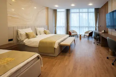 a hotel room with two beds and a desk at Kemer City Hotel İstanbul Airport in Kemerburgaz