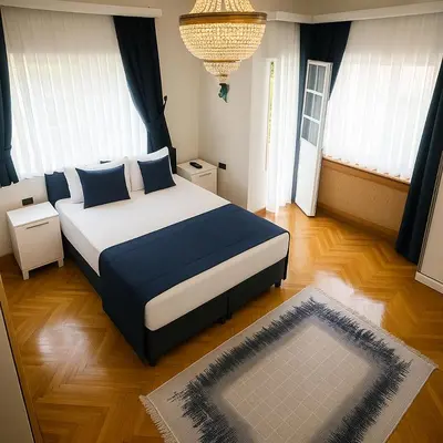a bedroom with a large bed with blue pillows at Palm Villa Büyükada in Istanbul