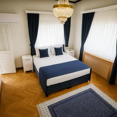 a bedroom with a large bed with blue pillows at Palm Villa Büyükada in Istanbul