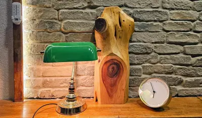 a desk with a lamp and a clock on it at MAHZEN Otel in Istanbul