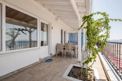 a balcony with a table and chairs and a plant at Marmara Yali Evi in Marmara